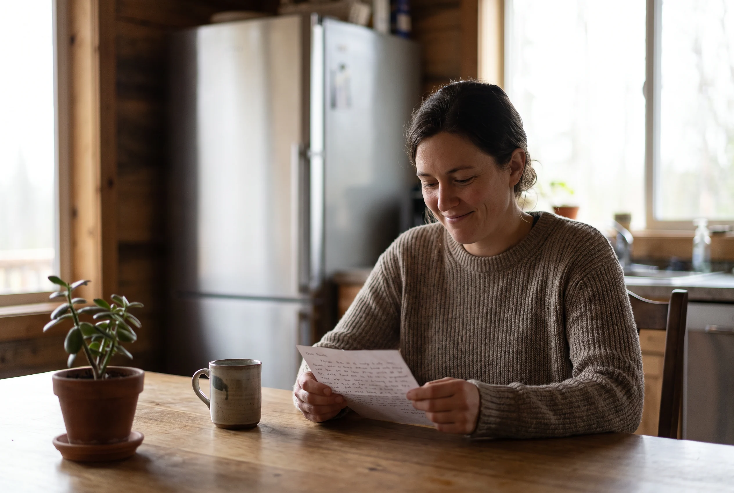 Homeowner considering an appliance care note in a kitchen